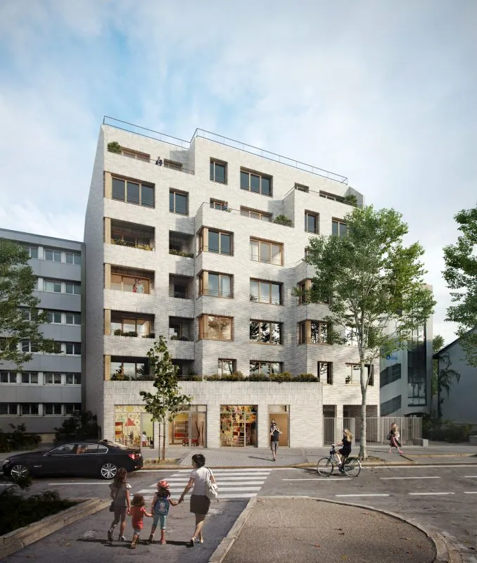 Perspective d'insertion urbaine du projet : immeuble en brique claire avec loggias plantées et commerce en rez-de-chaussée, à l'angle de l'avenue.